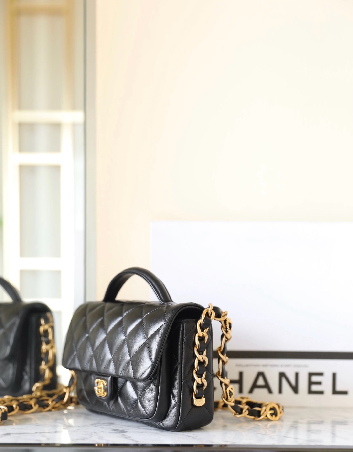 CHANEL 24a flap bag 20cm top handle black lambskin gold hardware